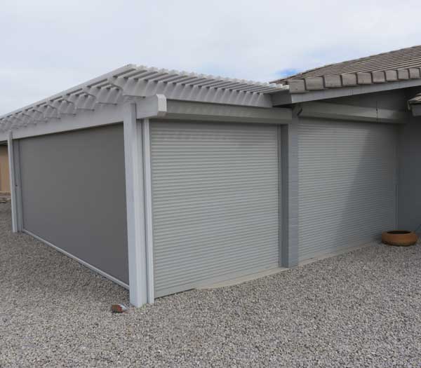 Garage doors protected with rolling shutters