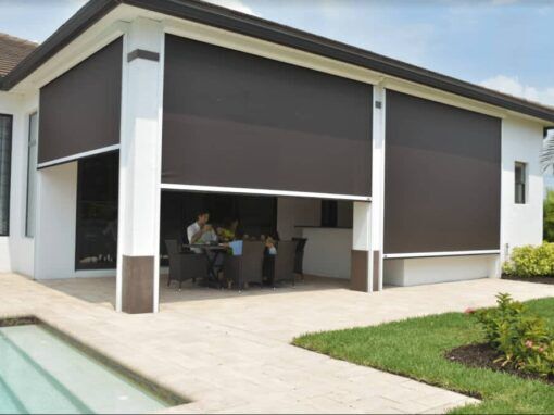 Modern balcony with a large, black perforated metal screen providing privacy and sun shading.
