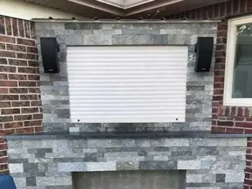 An outdoor TV enclosed with a rolling window.