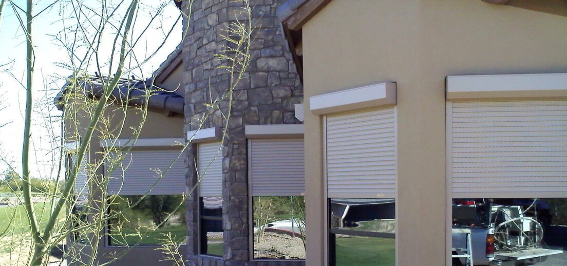 A family eats lunch at an outdoor dining area with an installed rolling sun screen.